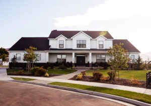 Modern white house with a black roof and landscaped yard in Salt Lake City.