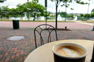 Relaxing outside a coffee shop with a latte while enjoying the view of the fountain