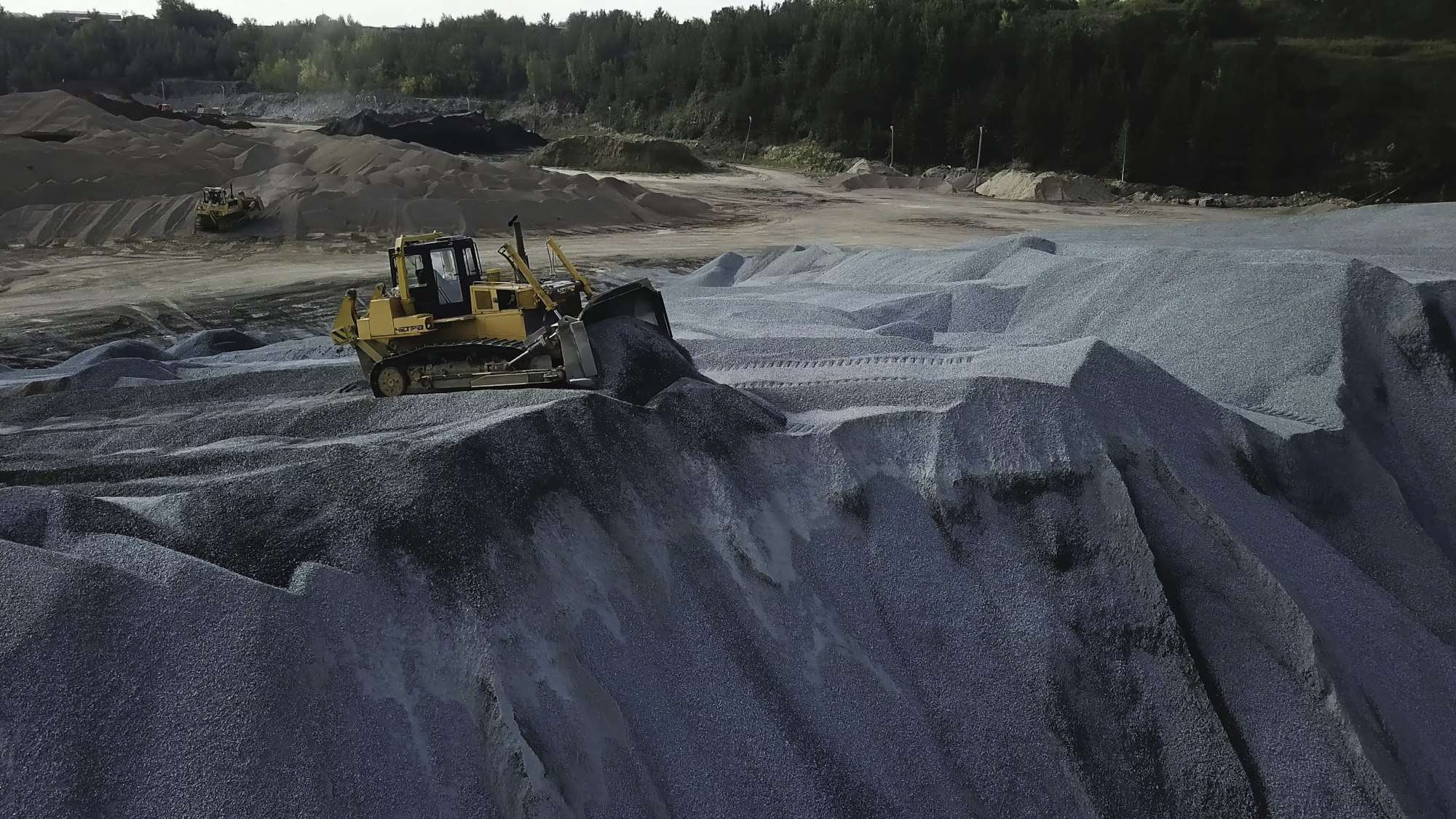 Big yellow excavator working in gravel quarry. Stock footage. Professional Mining industry concept