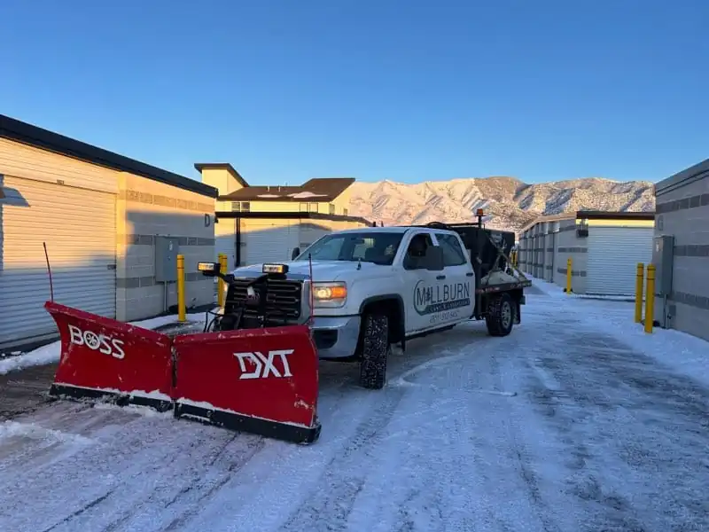 Millburn Lawn & Landscape snow plow truck providing commercial snow removal in Salem, Utah