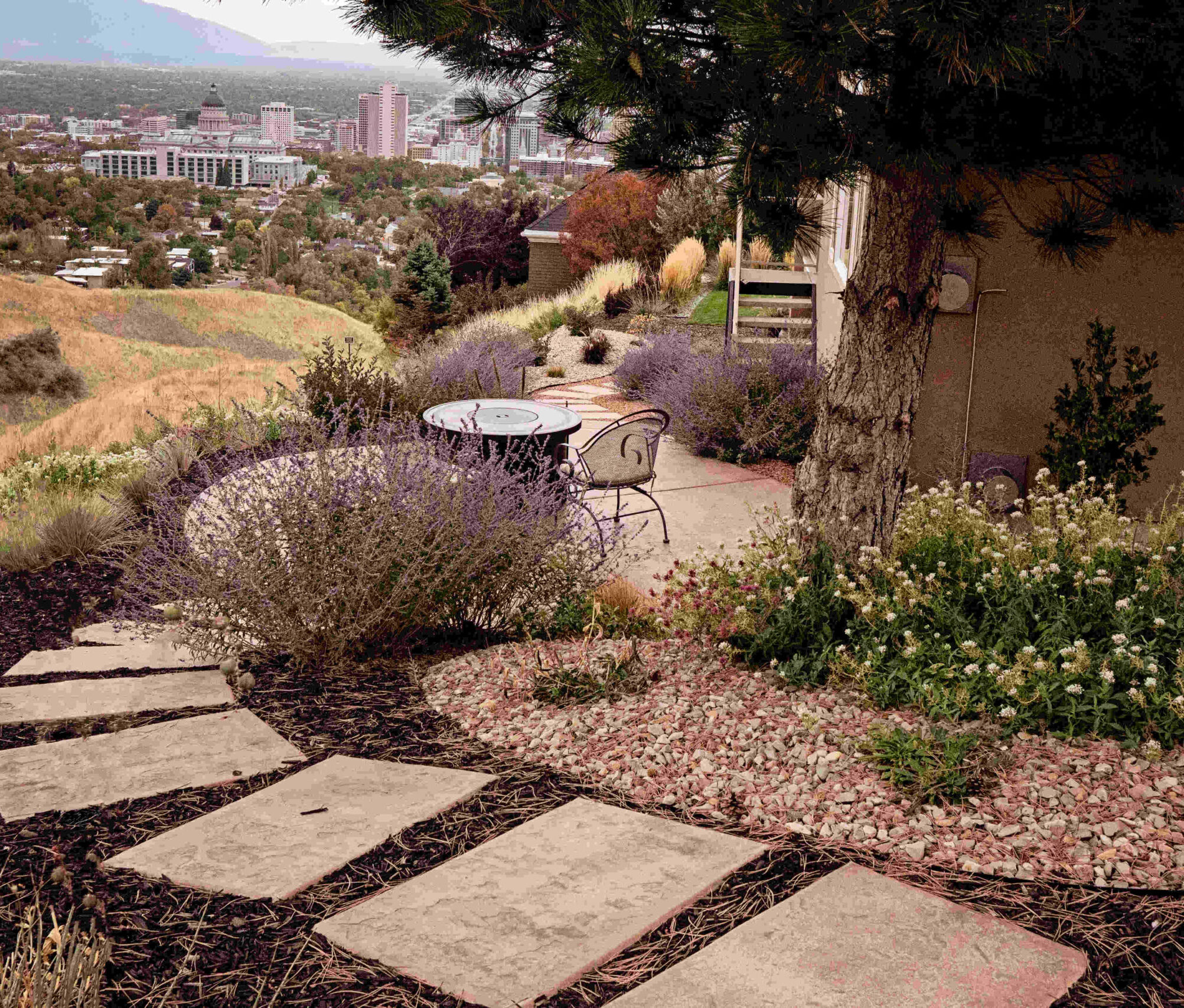A Herriman Utah front yard showing a beautiful right-sized lawn with drought-tolerant plantings, ornamental grasses and decorative rock replacing traditional turf