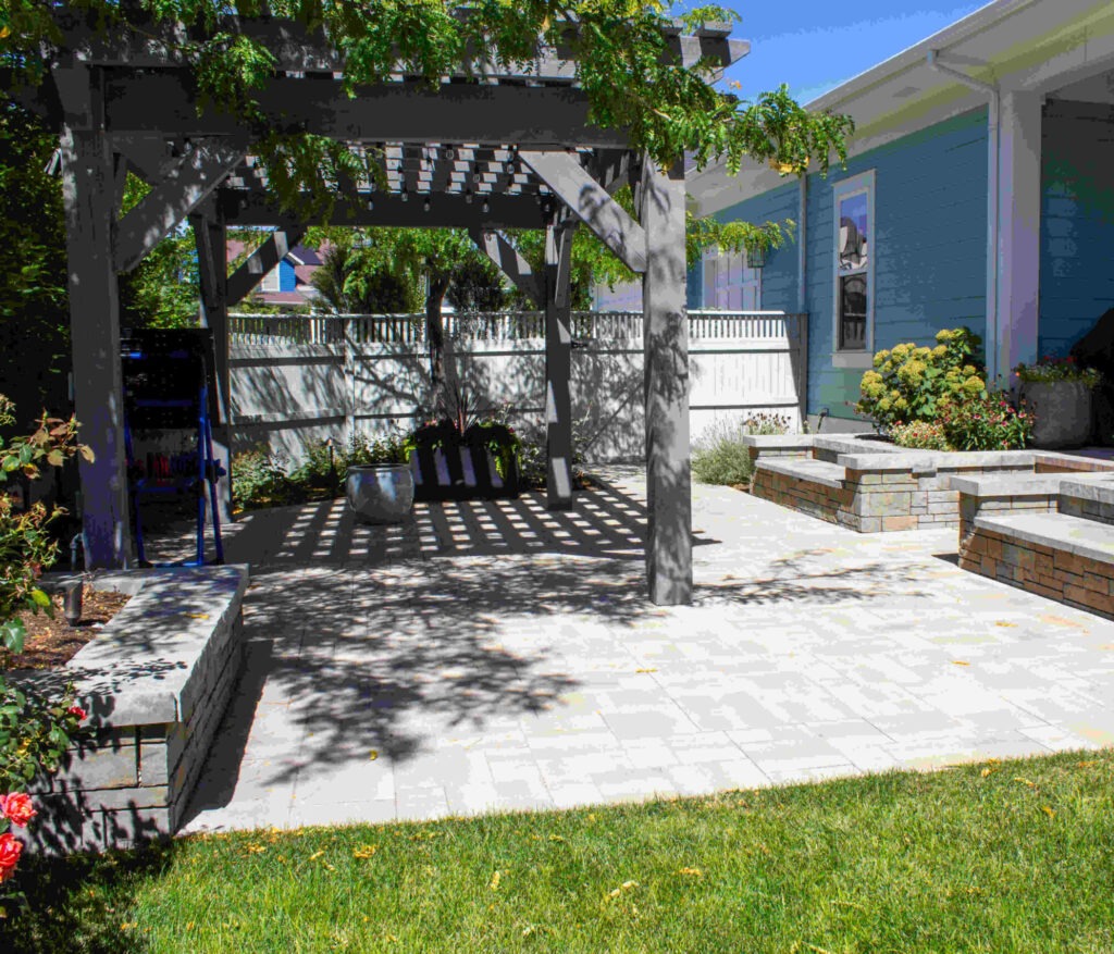 A stunning water-wise front yard landscape design in South Jordan Utah featuring ornamental grasses, flowering drought-tolerant perennials, and a widened decorative pathway