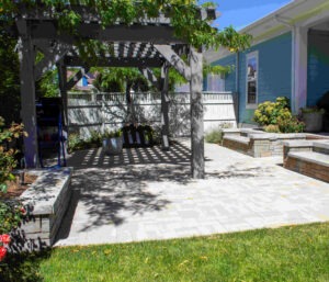 A stunning water-wise front yard landscape design in South Jordan Utah featuring ornamental grasses, flowering drought-tolerant perennials, and a widened decorative pathway