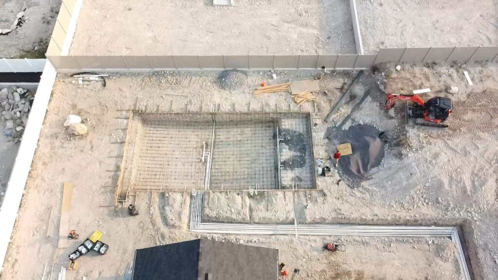 Landscape contractor reviewing a construction-ready design plan for a residential project in Bluffdale, Utah