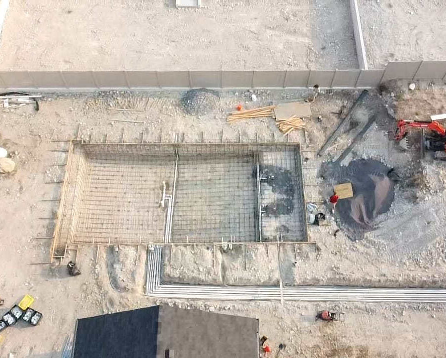 Landscape contractor reviewing a construction-ready design plan for a residential project in Bluffdale, Utah