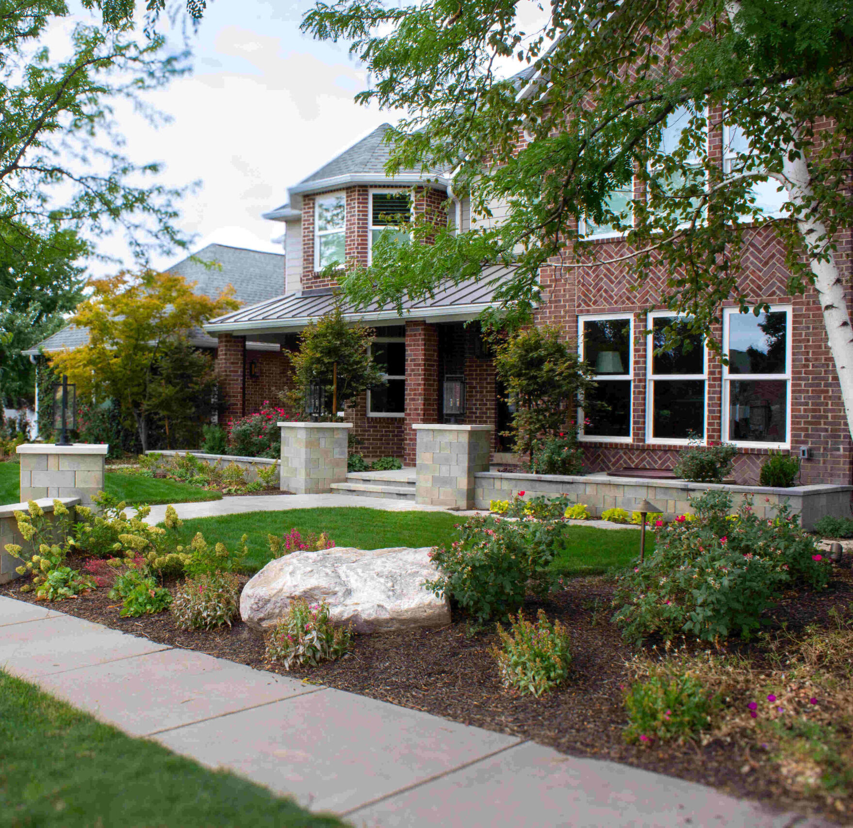 Professional landscape design with layered plant spacing and layout in a Herriman Utah residential front yard