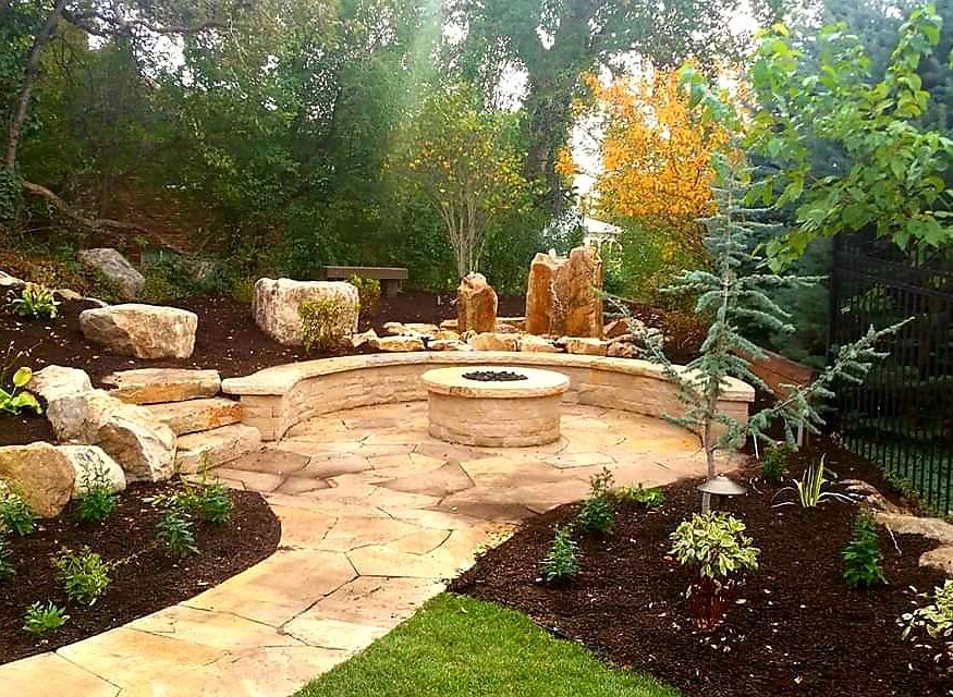 Homeowner reviewing a phased landscape installation budget plan with a contractor in Bluffdale, Utah