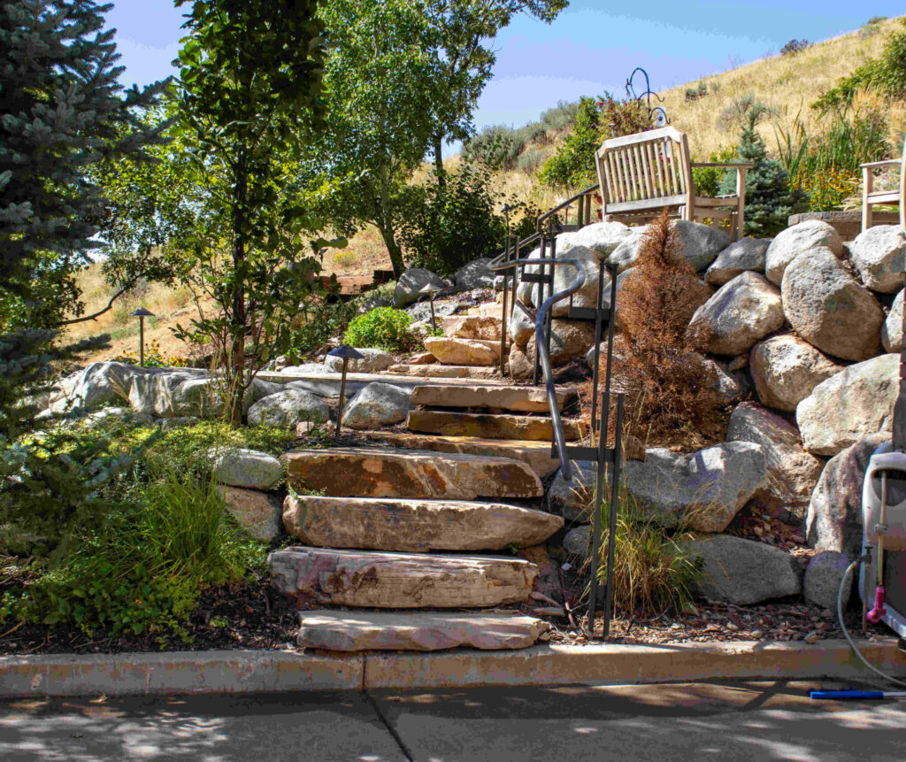 Custom retaining wall and landscape steps design in Bluffdale Utah by Millburn Lawn & Landscape