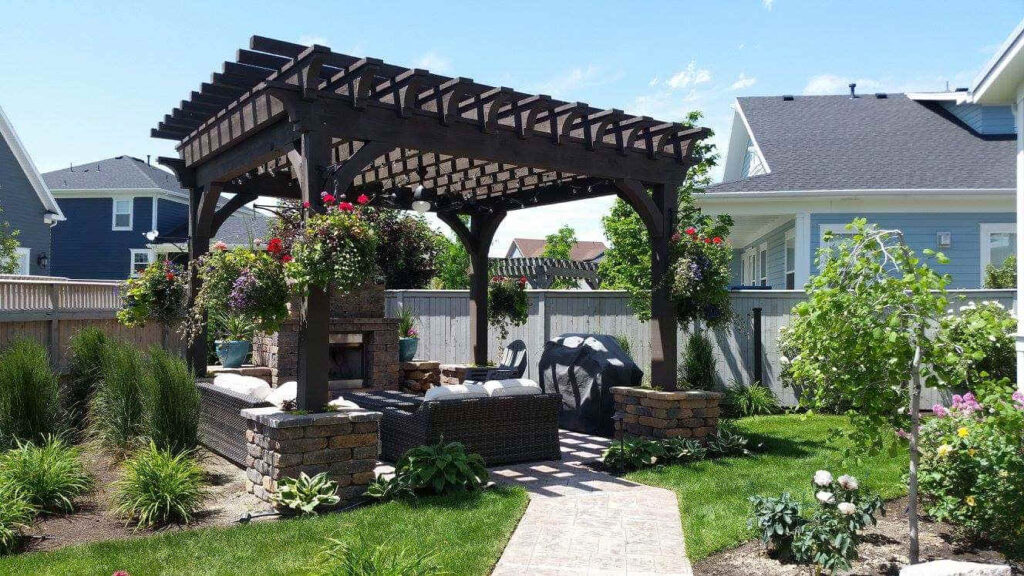 A finished large-scale outdoor renovation in Saratoga Springs Utah showing a new paver patio, aluminum pergola and drought-tolerant landscaping