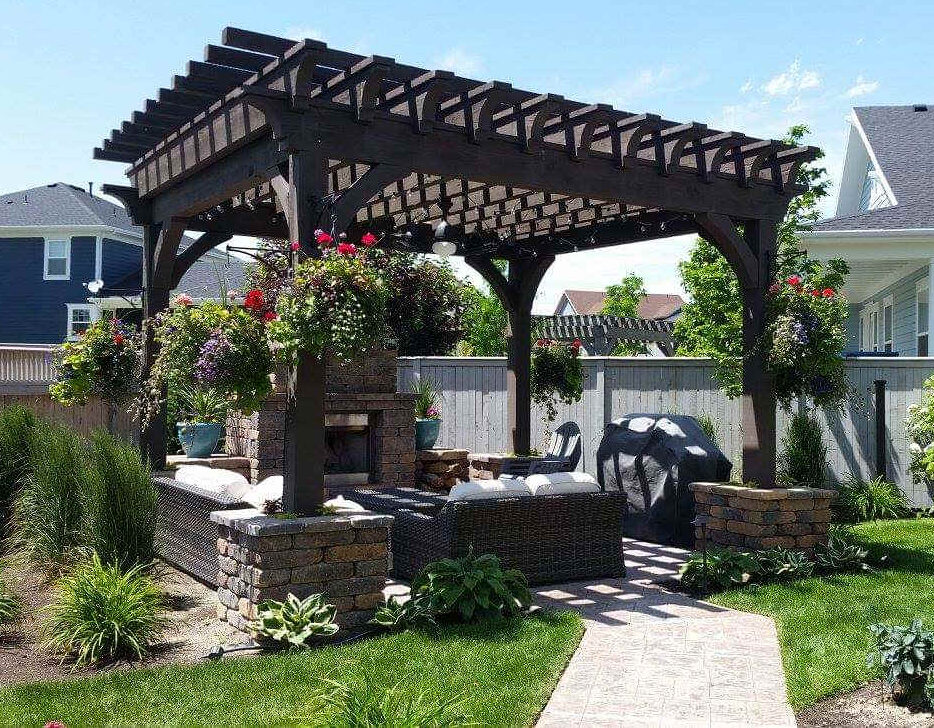 A finished large-scale outdoor renovation in Saratoga Springs Utah showing a new paver patio, aluminum pergola and drought-tolerant landscaping